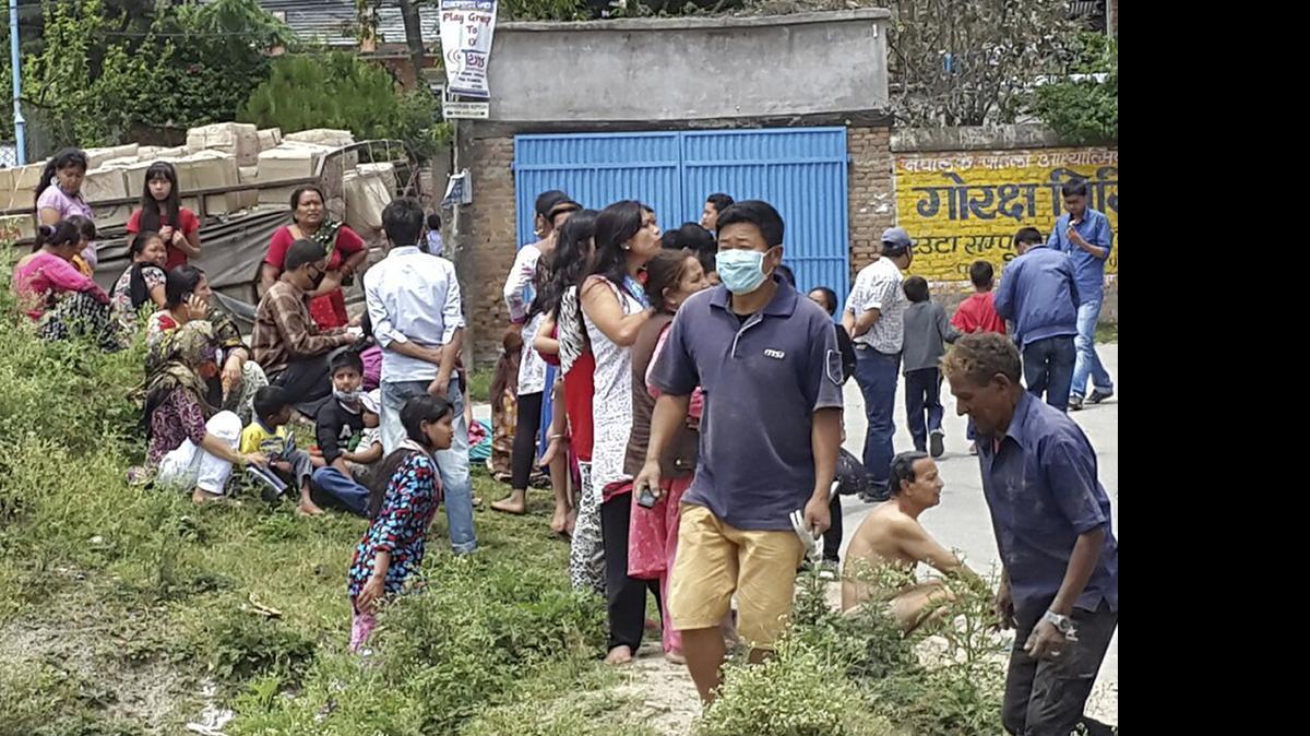 
In this photo provided by the International Organization for Migration (IOM), people gather in the street after an earthquake in Kathmandu, Nepal, Tuesday, May 12, 2015. A major earthquake hit Nepal near the Chinese border between the capital of Kathmandu and Mount Everest less than three weeks after the country was devastated by a quake.
