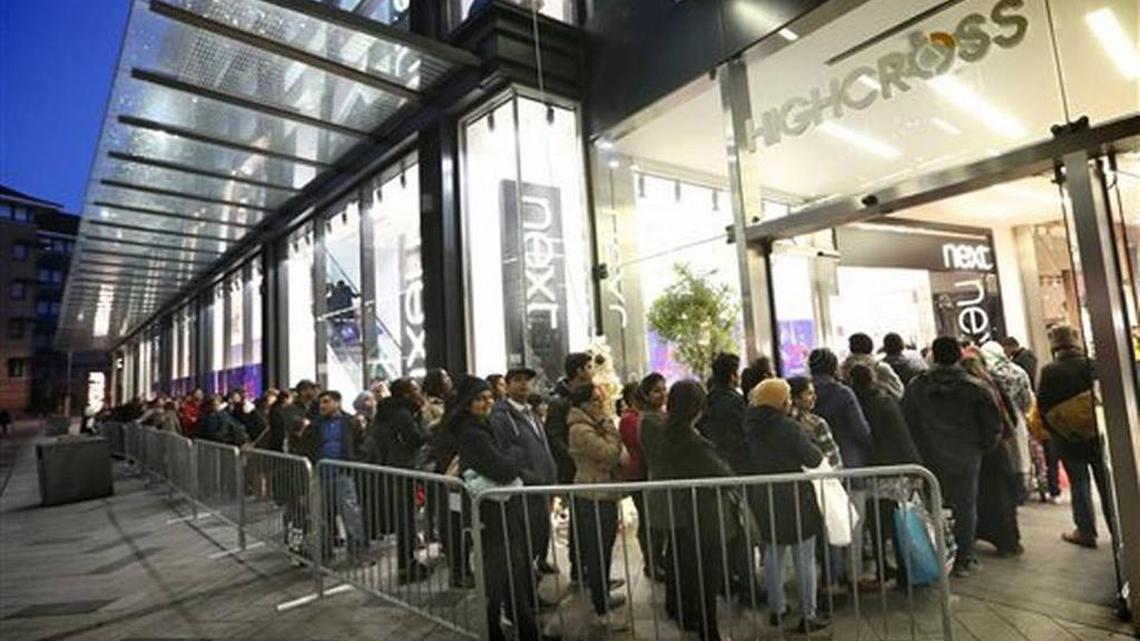Shoppers queue to enter a store in Leicester, England, at the start of the Boxing Day sales on Saturday Dec. 26, 2015.