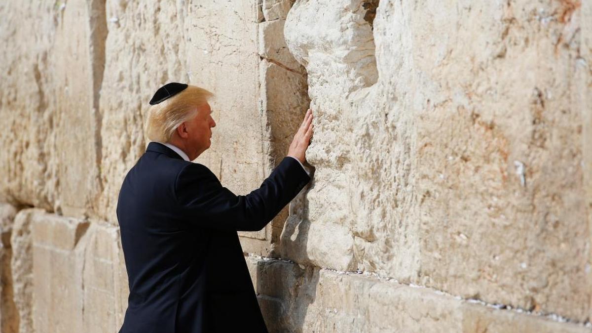 President Donald Trump touches the Western Wall, Judaism’s holiest prayer site, in Jerusalem’s Old City on May 22, 2017. Wednesday, Trump signed a waiver that delays moving the U.S. Embassy to Jerusalem from Tel Aviv.