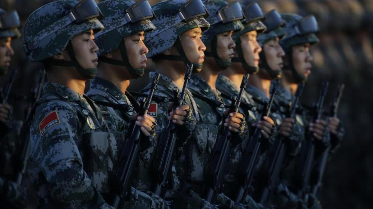 Soldiers of China's People Liberation Army (PLA) stand in line in front of Tiananmen Gate ahead of a military parade to commemorate the 70th anniversary of the end of World War II in Beijing on Sept. 3, 2015.