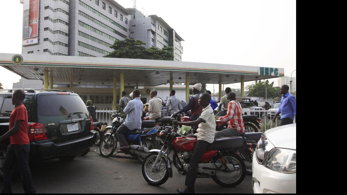 
People line up Jan. 11, 2012, to buy fuel at a government petrol station on the third day of nation wide strike following the removal of a fuel subsidy in Lagos, Nigeria. Nigerian airlines grounded flights May 23, 2015, as the months-long fuel shortage worsened, aggravated by a strike disrupting fuel deliveries in Africa's biggest oil producer.
