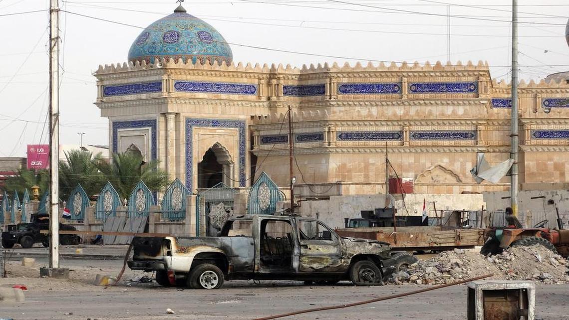 
 Iraqi security forces stand guard last week near destroyed vehicles and a mosque after overnight clashes with Islamic State in Ramadi, the capital of Anbar province. After years of reluctance to arm and train the tribal fighters, Iraqi authorities are signing up recruits for a new Sunni militia to help its security forces take back Anbar province. Government officials have pledged that at least 6,000 Sunni tribesmen will be trained, but by Tuesday fewer than 1,000 people had signed up.
