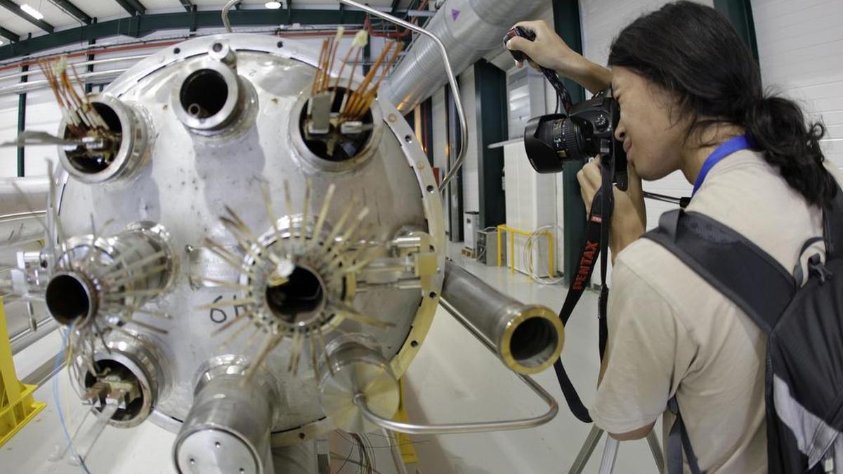 
In this Aug. 7, 2010, picture a photographer takes a picture in the assembly room of the elements of the LHC (large hadron collider) at the European Particle Physics laboratory CERN in Geneva, Switzerland.
