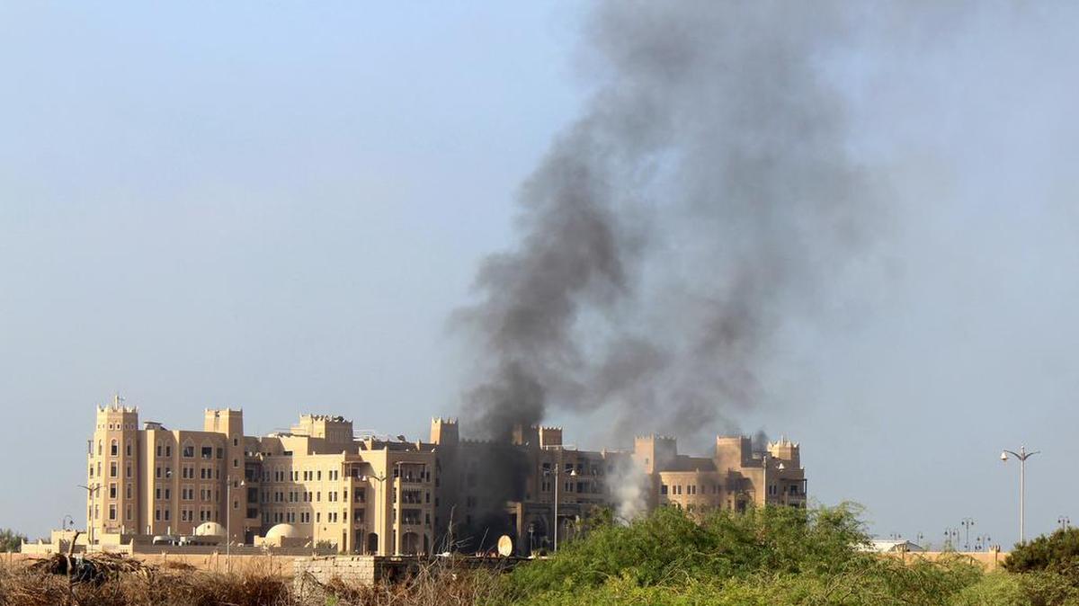 Smoke rises following an explosion that hit Hotel al-Qasr where Cabinet members and other government officials are staying, in the southern port city of Aden, Yemen, Tuesday, Oct. 6, 2015.