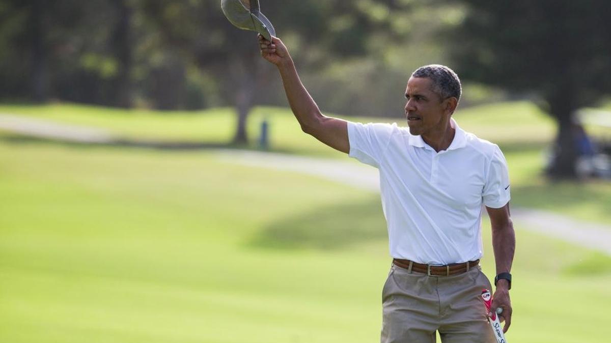 President Barack Obama tips his hat to the crowd Monday, Dec. 28, 2015, after finishing a round of golf at Mid-Pacific Country Club during his family vacation in Kailua, Hawaii.