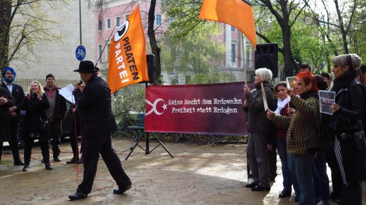 Members of Germany’s Pirates Party march in front of the Turkish embassy in Berlin on Friday to protest Chancellor Angela Merkel’s decision to allow consideration of a criminal complaint filed by Turkish President Recep Tayyip Erdogan against a comic who recited a satirical poem on German television. The poster reads, “Freedom instead of Erdogan.”