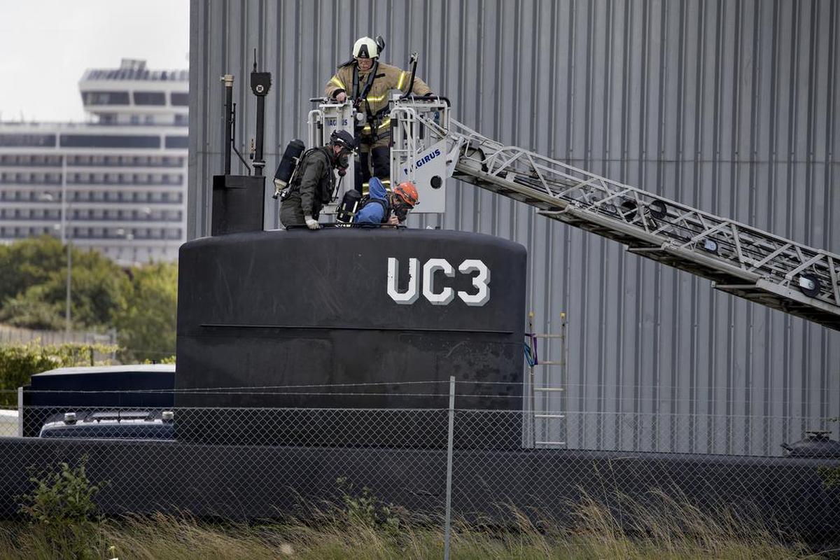 Police technicians board the amateur-built submarine UC3 Nautilus on a pier in Copenhagen harbour, Denmark, Sunday, Aug. 13, 2017, to conduct forensic probes in connection with a murder investigation. Danish police say they have not found the body of missing Swedish journalist Kim Wall inside the submarine that sunk off the Nordic country's eastern coast last week.