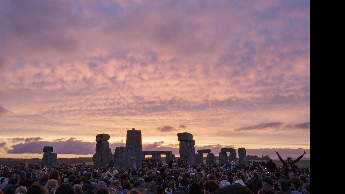 
The sun rises as thousands of revelers gather at the ancient stone circle Stonehenge to celebrate the summer solstice, the longest day of the year, near Salisbury, England, Sunday, June 21, 2015. 
