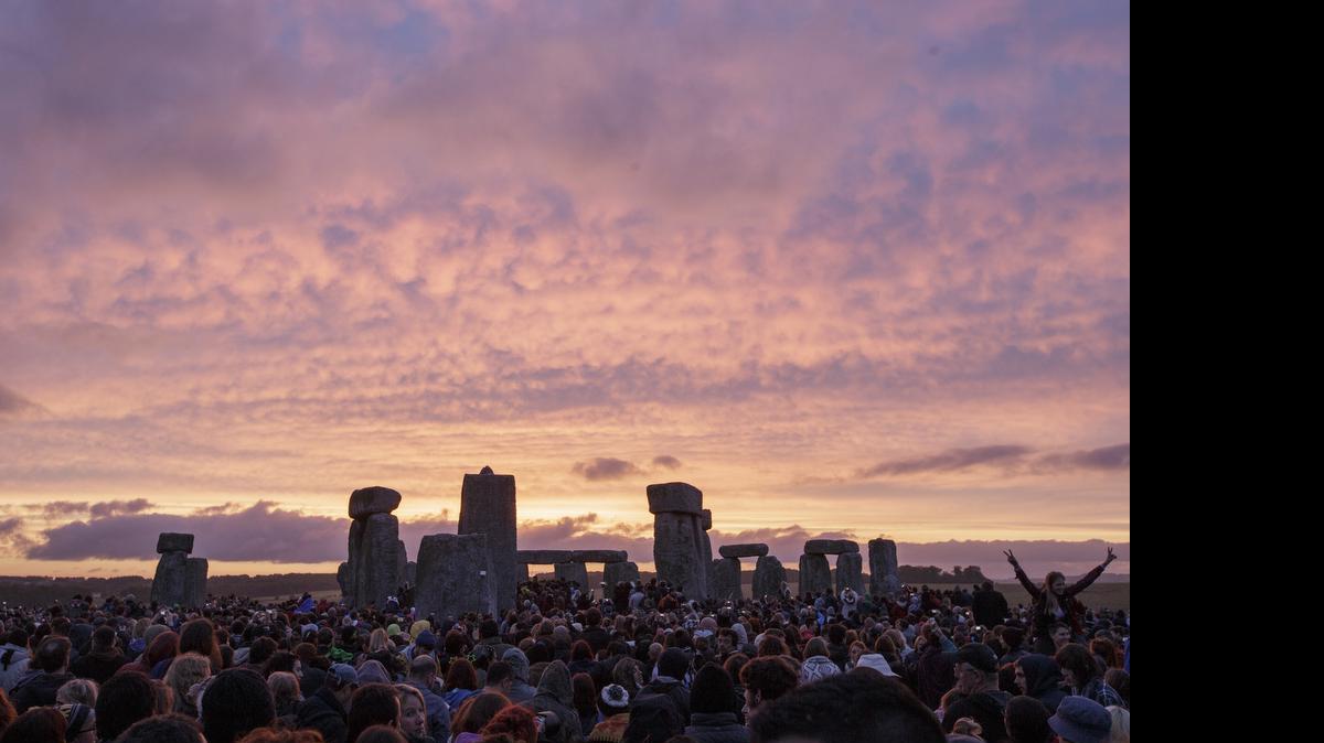 
The sun rises as thousands of revelers gather at the ancient stone circle Stonehenge to celebrate the summer solstice, the longest day of the year, near Salisbury, England, Sunday, June 21, 2015. 
