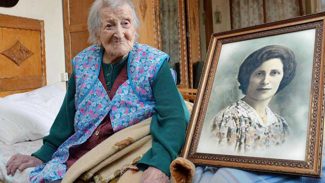 Emma Morano is now the oldest person in the world at 116. She is believed to be the last surviving person in the world who was born in the 1800s. A picture of her when she was young sits next to her.