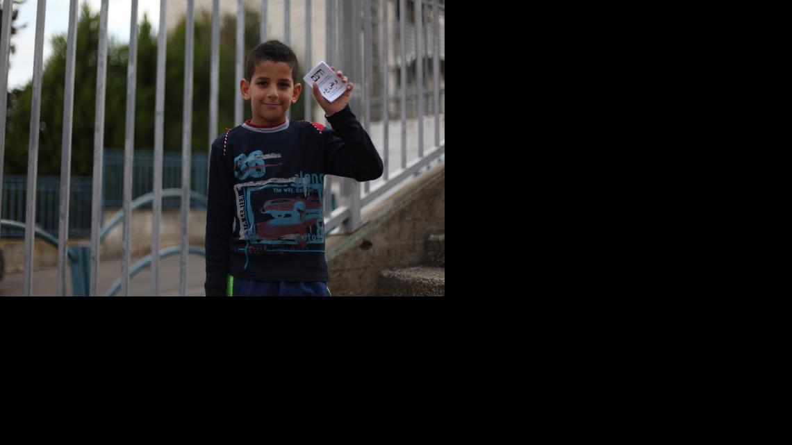 
A child in Nazareth holds the election ticket for the newly formed Joint List that unified four Arab parties into one. Arab citizens of Israel voted in record numbers Tuesday to propel the Joint List to the third-largest party in Knesset, Israel's parliament. 
