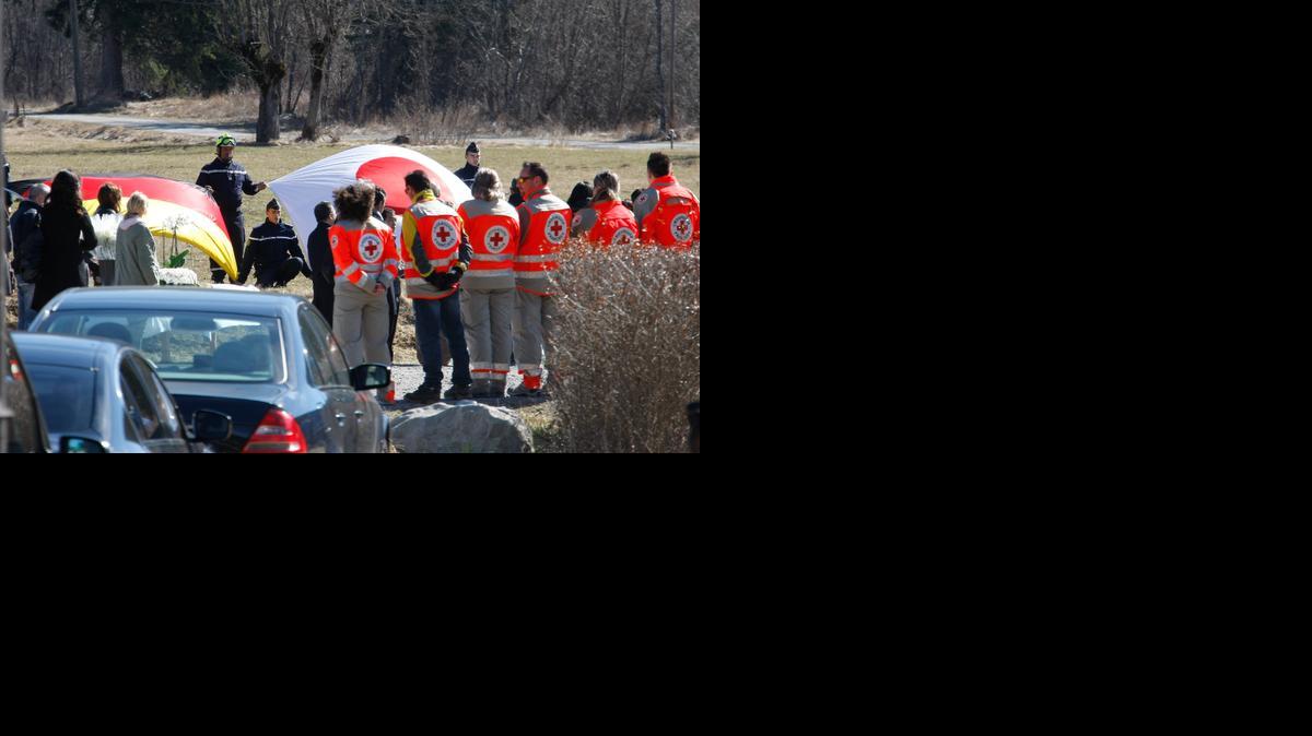 
The German, left, and Japanese flags are deployed during an homage ceremony with family members of Japanese victims in the area where the Germanwings jetliner crashed in the French Alps, in Le Vernet, France, Sunday, March 29, 2015. 
