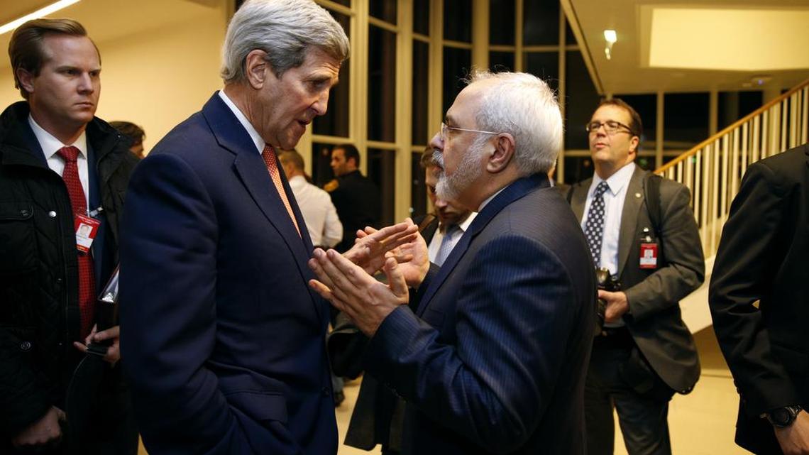 U.S. Secretary of State John Kerry talks with Iranian Foreign Minister Mohammad Javad Zarif, right, after the International Atomic Energy Agency (IAEA) verified that Iran has met all conditions under the nuclear deal, in Vienna, Jan. 16, 2016.