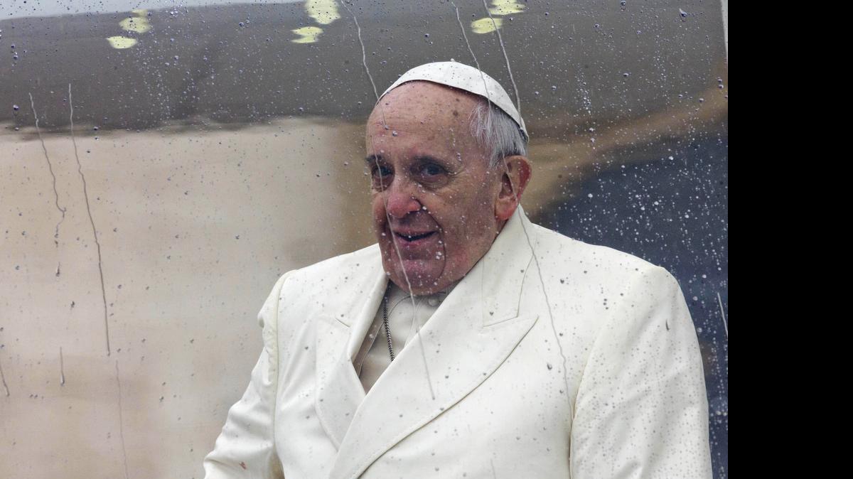 
In this Wednesday, Jan. 22, 2014 file photo Pope Francis sits in his rain-covered pope-mobile as he leaves after his weekly general audience in St. Peter's Square at the Vatican. Pope Francis called Thursday for a bold cultural revolution to correct what he calls the "structurally perverse" economic system of the rich exploiting the poor that is turning Earth into an "immense pile of filth." 
