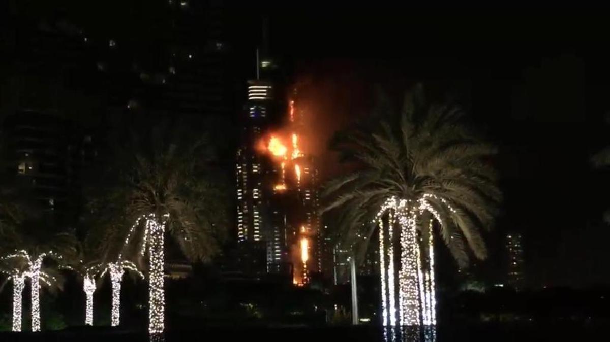 This image taken from AP video shows smoke and flames pouring from a residential building, which also contains the Address Downtown Hotel, in Dubai, United Arab Emirates, Thursday evening, Dec. 31, 2015.