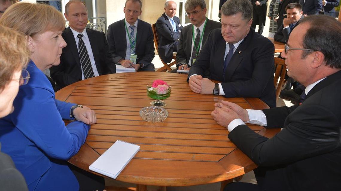 
Sitting around a table for talks are from left, clockwise: German Chancellor Angela Merkel, Russian President Vladimir Putin, Ukrainian President Petro Poroshenko and French President François Hollande, during an informal meeting in Paris, Friday, Oct. 2, 2015. Representatives of Ukraine and Russia will face off on the United Nations Security Council if Ukraine wins an expected election to the committee on Thursday, Oct. 15, 2015.
