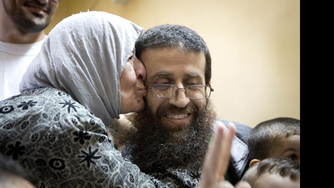 
Palestinian Khader Adnan is greeted by Palestinians after his release from an Israeli prison in the West Bank village of Arrabeh near Jenin, Sunday, July 12, 2015.  Adnan had recently ended a 55-day hunger strike. 
