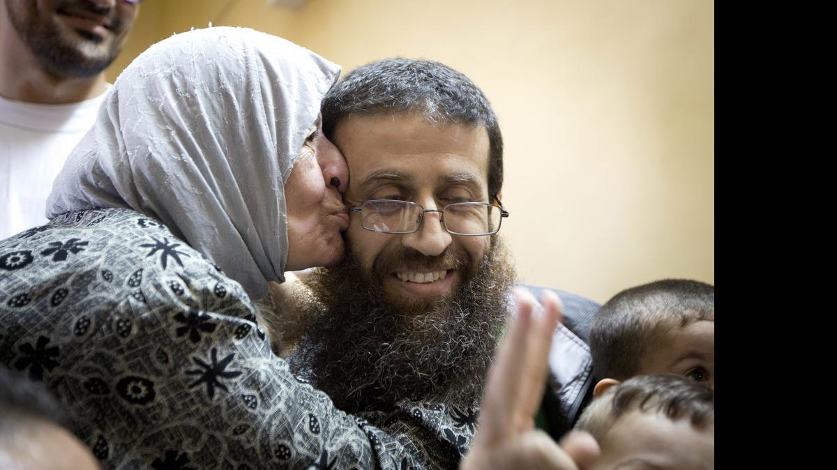 
Palestinian Khader Adnan is greeted by Palestinians after his release from an Israeli prison in the West Bank village of Arrabeh near Jenin, Sunday, July 12, 2015.  Adnan had recently ended a 55-day hunger strike. 
