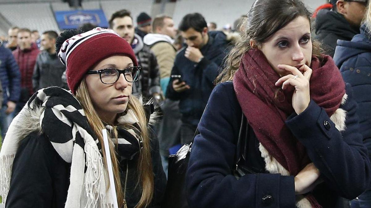 Soccer fans wait on the field at the Stade de France stadium on Friday night. Terrorist suicide bombers failed to gain admission to the stadium, which experts say probably had been the primary goal of the attackers.