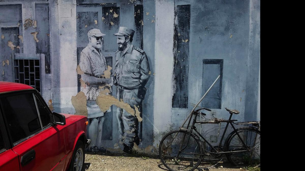 
A mural of author Ernest Hemingway and Fidel Castro shaking hands covers a downtown parking lot in Havana, Cuba, Monday, June 22, 2015. Cuban architects, engineers and workmen will construct a two-story laboratory where thousands of photos, books and letters to and from Hemingway can be treated and preserved. 
