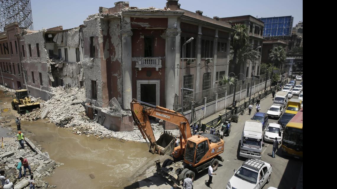 
Workers clear rubble at the site of an explosion near the Italian Consulate in downtown, Cairo, Egypt, on Saturday, July 11, 2015. Italy’s foreign minister vowed that his country would not be intimidated after a deadly explosion Saturday morning killed one person and heavily damaged the Italian Consulate in the Egyptian capital.
