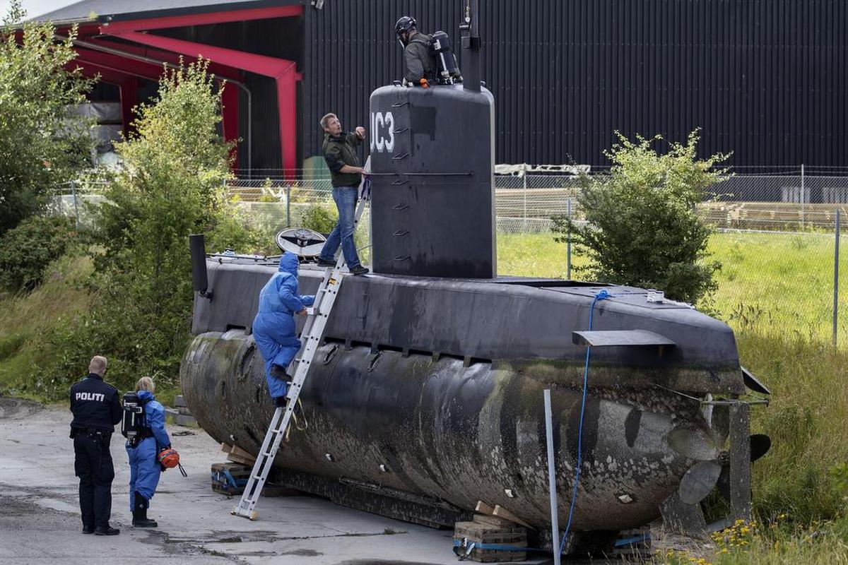Police technicians board the amateur -built submarine UC3 Nautilus on a pier in Copenhagen harbour, Denmark, Sunday, Aug. 13, 2017, to conduct forensic probes in connection with a murder investigation. Danish police say they have not found the body of missing Swedish journalist Kim Wall inside the submarine that sunk off the Nordic country’s eastern coast last week.