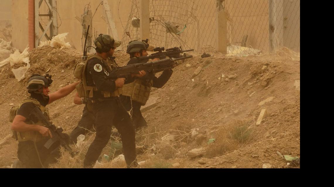
Security forces defend their headquarters against attacks by Islamic State extremists during sand storm in the eastern part of Ramadi, the capital of Anbar province, 115 kilometers (70 miles) west of Baghdad, Iraq, Thursday, May 14, 2015. Islamic State extremists tend to take advantage of bad weather when they attack Iraqi security forces positions, an Iraqi officer said. 
