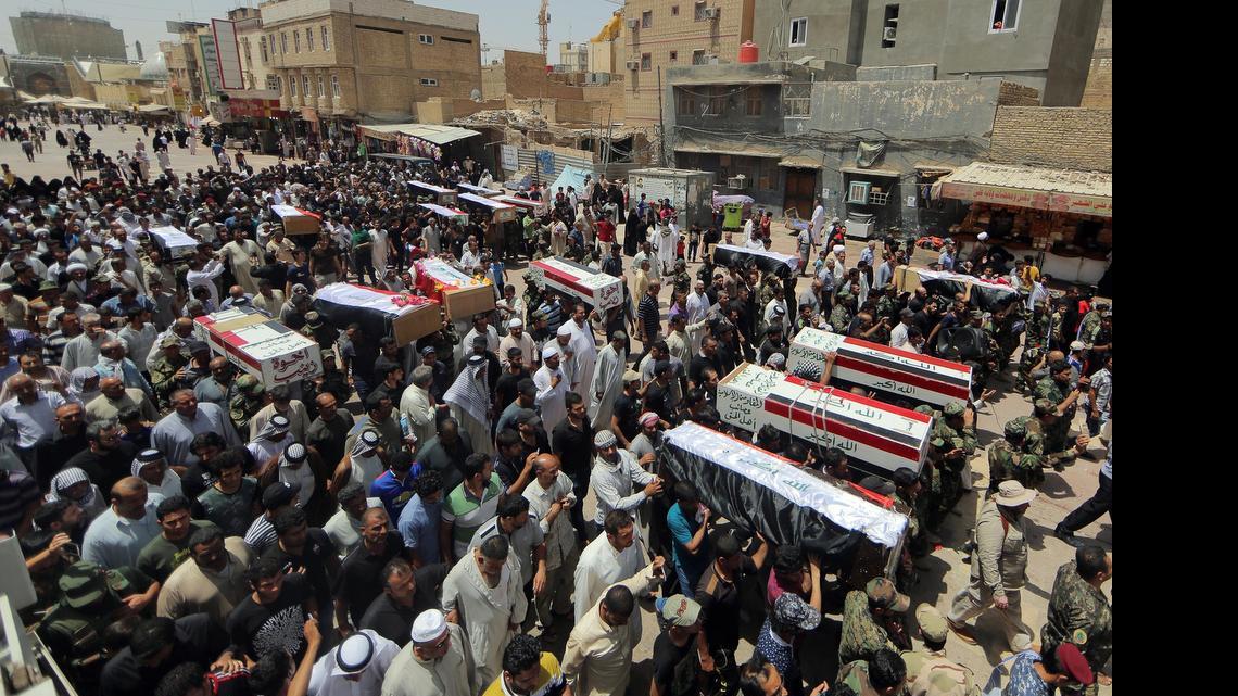 
Mourners on June 8, 2015, carry the flag-draped coffins of 15 militia members of a Shiite group, Asaib Ahl al-Haq, or League of the Righteous, who were killed in Beiji, Iraq, fighting with Islamic State militants, according to their families.  
