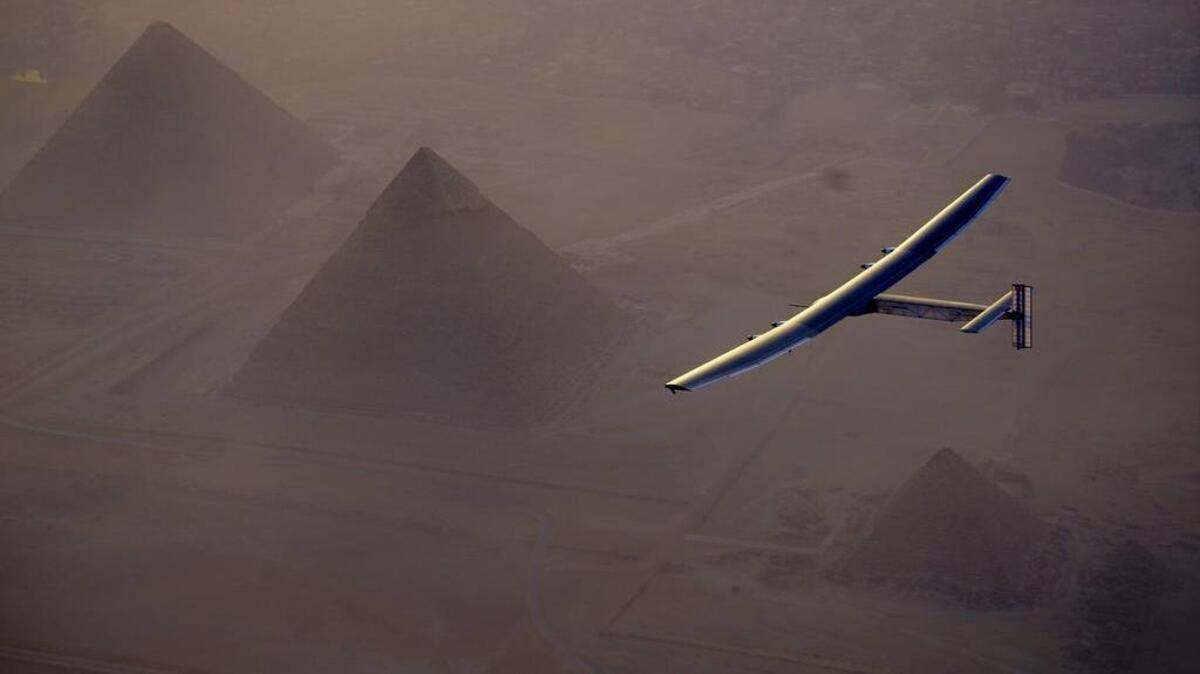 The Solar Impulse 2 flies over the pyramids, Egypt Cairo, on July 13. The experimental solar-powered airplane completed its round-the-world journey Monday, July 25, 2016, in Abu Dhabi.