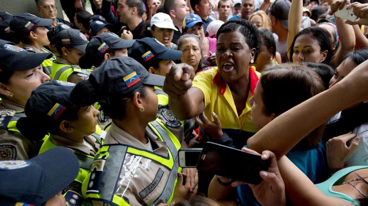Anti-government demonstrators argued with police blocking them from reaching the National Electoral Council (CNE) in Caracas, Venezuela, on Wednesday. The demonstrators were demanding that election officials start counting signatures that could lead to a presidential recall vote.