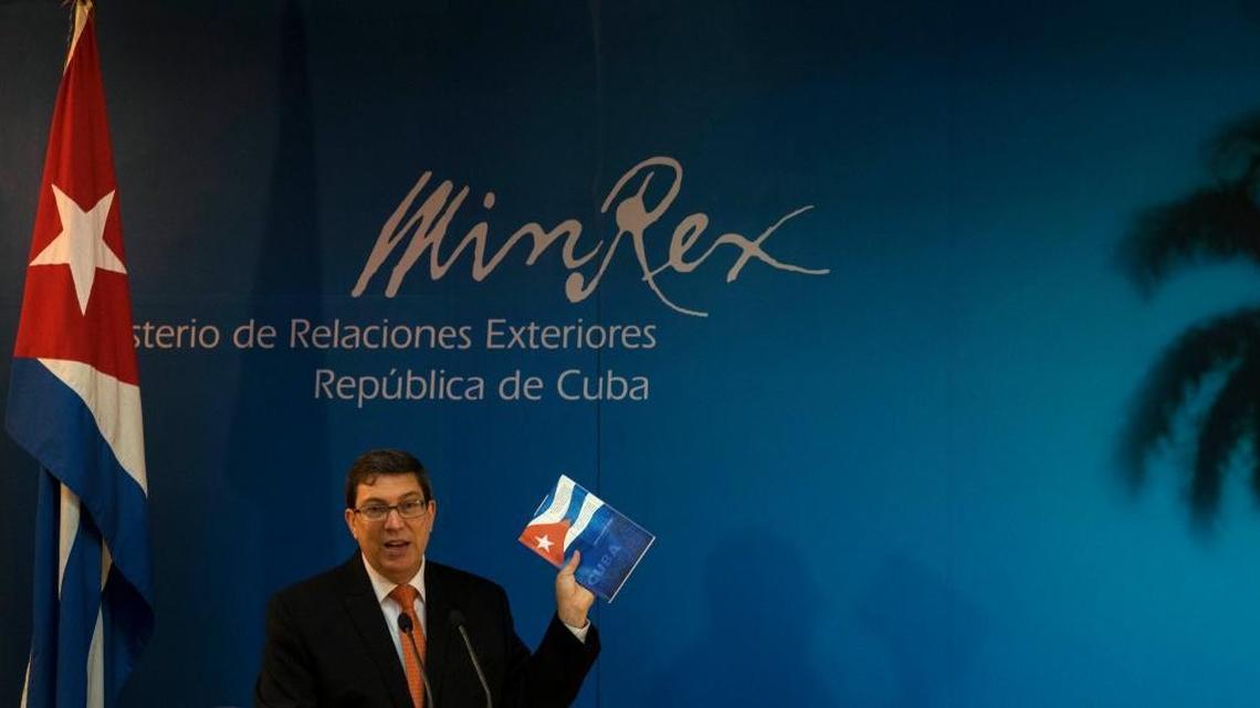 
Cuban Foreign Minister Bruno Rodriguez holds up the government's annual report on what Cuba loses due to the U.S. embargo, as he gives a news conference in Havana, Cuba, Wednesday, Sept. 16, 2015. Bruno reiterated that the continuation, or ceasing, of the U.S. embargo depends on the U.S., not Cuba, but that talks between the two countries to normalize relations are on the right track.

