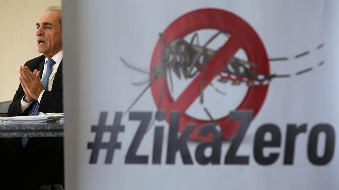 Brazil’s Health Minister Marcelo Castro speaks during an interview at the Health Ministry headquarters, in Brasilia on Friday, Feb. 12, 2016. Castro made his remarks with a poster with an image of an Aedes aegypti mosquito and a text in Portuguese that reads “Zero Zika.”