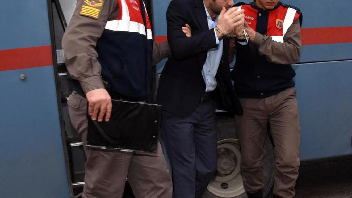 Prison guards escort Asem Alfrhad before his trial in Aegean resort of Bodrum, Turkey, Thursday Feb. 11, 2016. Two alleged people-smugglers are on trial accused of causing the death of 3-year-old Syrian migrant boy Aylan Kurdi and four other people. The image of the boy — his lifeless body lying face down on a beach in Bodrum — galvanized world attention on the refugee crisis, graphically illustrating the magnitude of the suffering and the treacherous journeys the migrants risk.
