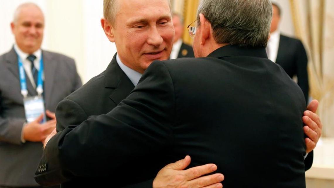 Russian President Vladimir Putin and Cuban President Raul Castro, right, embrace each other during their meeting in the Kremlin in Moscow, Thursday, May 7, 2015.