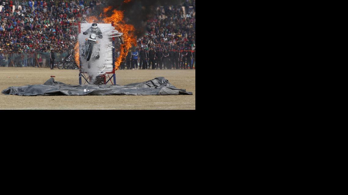 
A Jammu and Kashmir state policeman performs a motorcycle stunt during Republic Day parade in Jammu, India, Monday, Jan. 26, 2015. Republic Day marks the anniversary of India’s democratic constitution taking force in 1950. 
