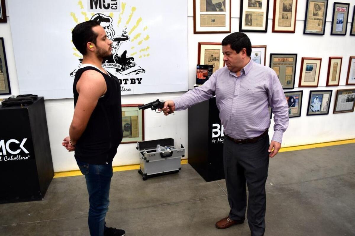 Miguel Caballero shoots Andres Paez, who is wearing one of the company’s bulletproof T-shirts in Bogotá, Colombia. The 25-year-old company is starting to sell its clothing in Florida under the name MC Armor.