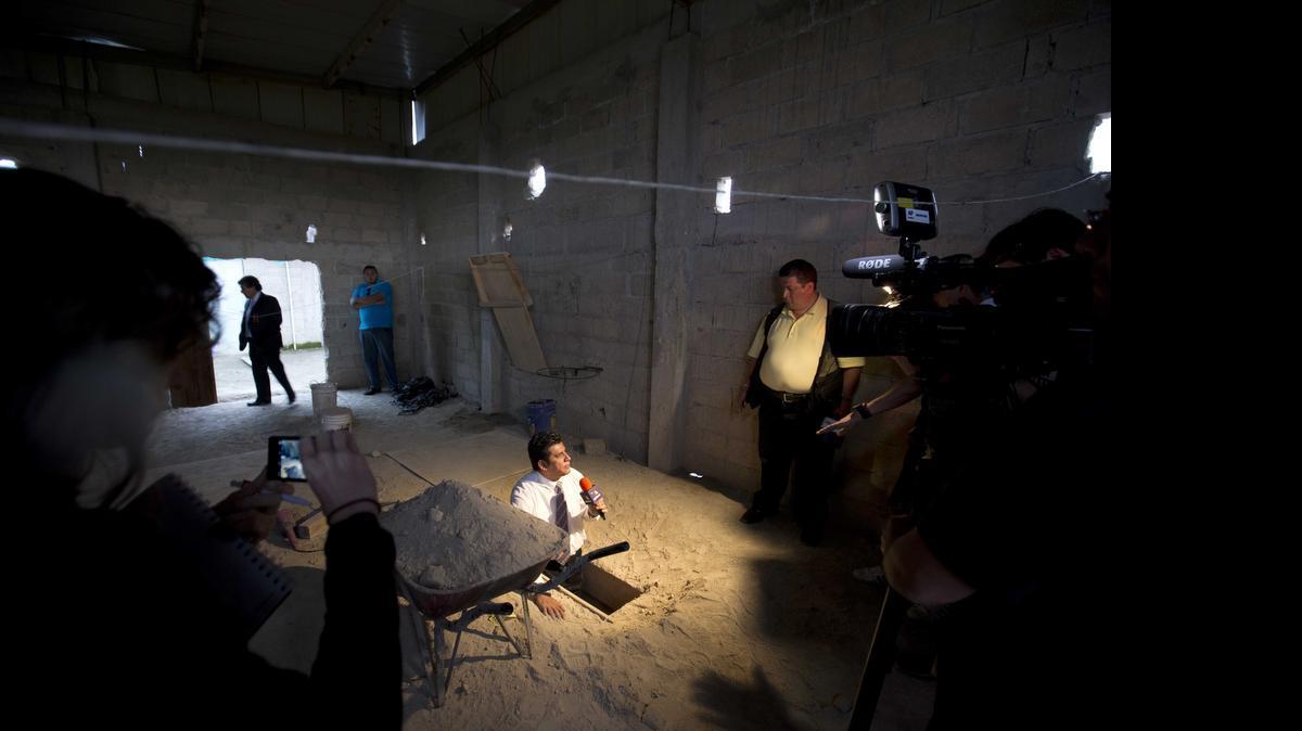 
A journalist reports from the exit of the tunnel that according to authorities, drug lord Joaquin "El Chapo" Guzman used to escape from the Altiplano maximum security prison in Almoloya, west of Mexico City, Tuesday, July 14, 2015
