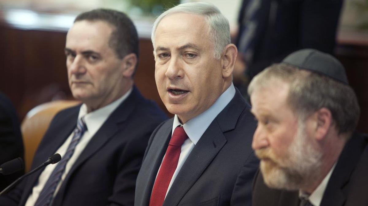 Israeli Prime Minister Benjamin Netanyahu, center, attends a weekly cabinet meeting in Jerusalem on Sunday, Jan. 17, 2016. The Israeli government gave a number of tour operators the tenders for the business of flying high school students to Poland. The cost of the trips have long caused controversy within Israel. The project to send Israeli schoolchildren to Poland first began in the late 1980s, and it is estimated that about half of the Jewish schools in Israel offer the journeys to their pupils