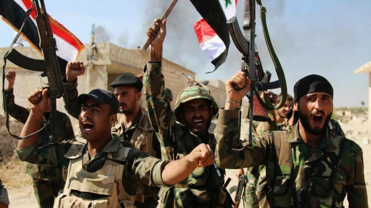 
Syrian government soldiers on Sunday celebrated the capture of Achan in Hama province after intense Russia air strikes. 
