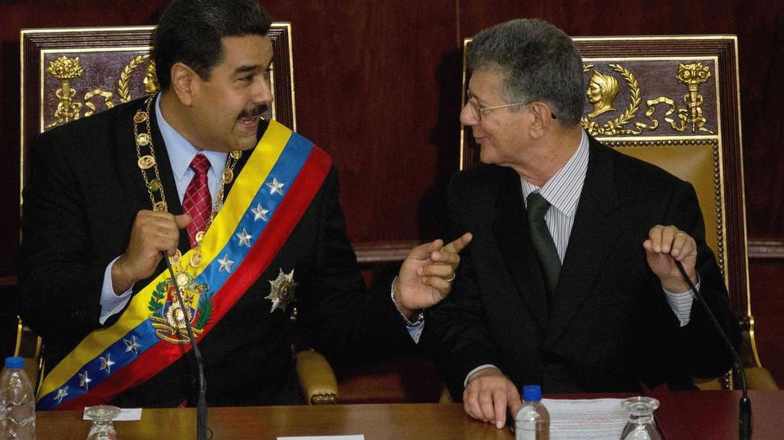 Venezuela's President Nicolas Maduro, left, speaks with President of the National Assembly Henry Ramos Allup, prior to delivering his annual state of the nation report in Caracas, Venezuela, Friday, Jan. 15, 2016. Ahead of a surprise dire economic data release, Maduro said he would declare an economic emergency giving him 60 days to unilaterally enact sweeping reforms. The decree will be debated in the newly-seated opposition congress next week.