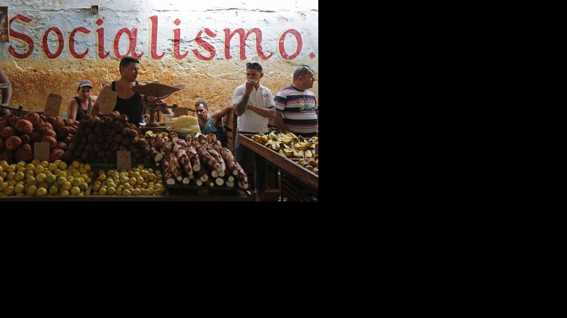 
Workers stand behind their food stalls at a state-run market in Havana, Cuba, Saturday, Dec. 20, 2014. 
