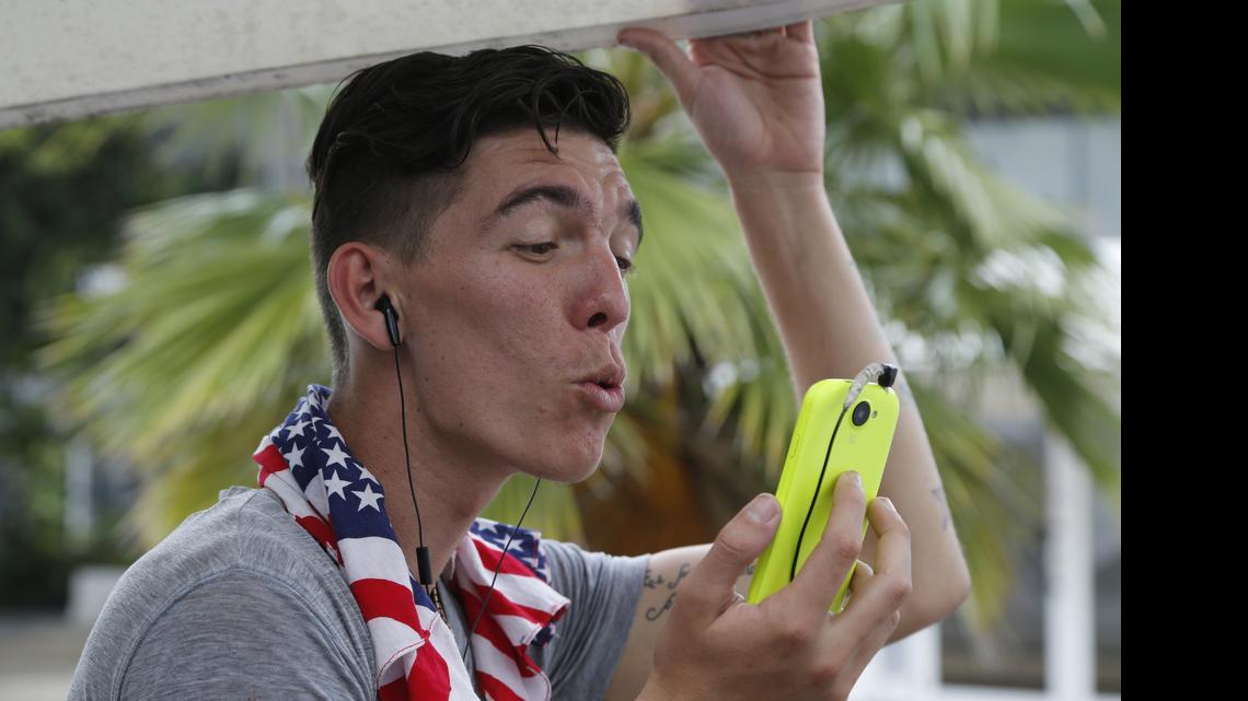 
Adonis Ortiz chats with his father, who lives in the U.S., using a free Wi-Fi network at a center run by famed artist Kcho, in Havana on March 11. Cuba says it's expanding Internet access by adding Wi-Fi capacity to dozens of state-run Internet centers and more than halving the cost that users pay for an hour online.
