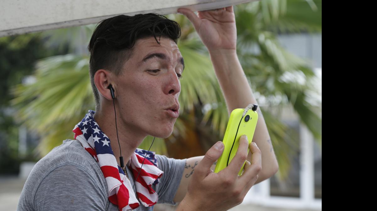 
Adonis Ortiz chats with his father, who lives in the U.S., using a free Wi-Fi network at a center run by famed artist Kcho, in Havana on March 11. Cuba says it's expanding Internet access by adding Wi-Fi capacity to dozens of state-run Internet centers and more than halving the cost that users pay for an hour online.
