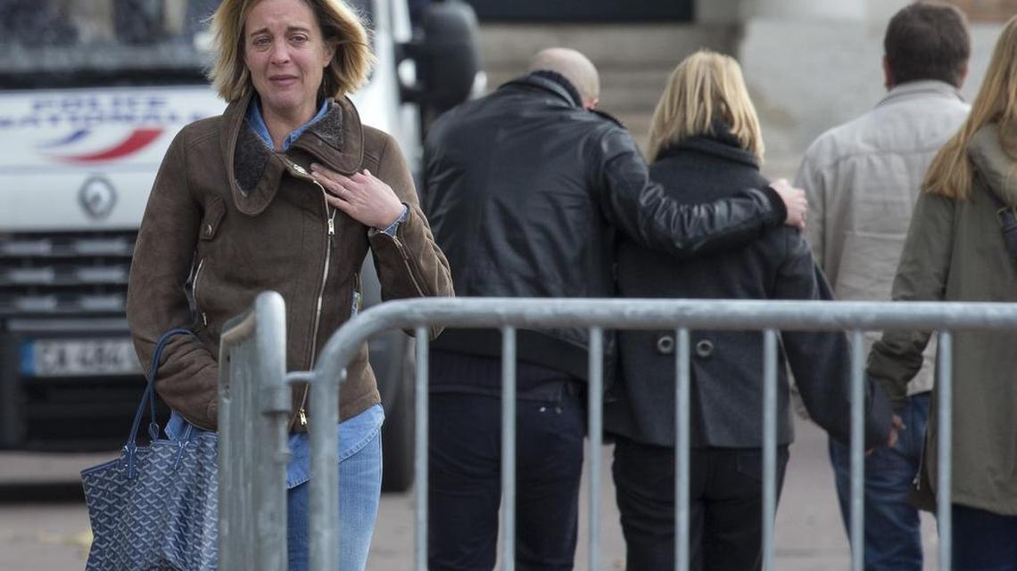 A woman reacts outside the Paris morgue in Paris, Saturday, Nov. 14, 2015.