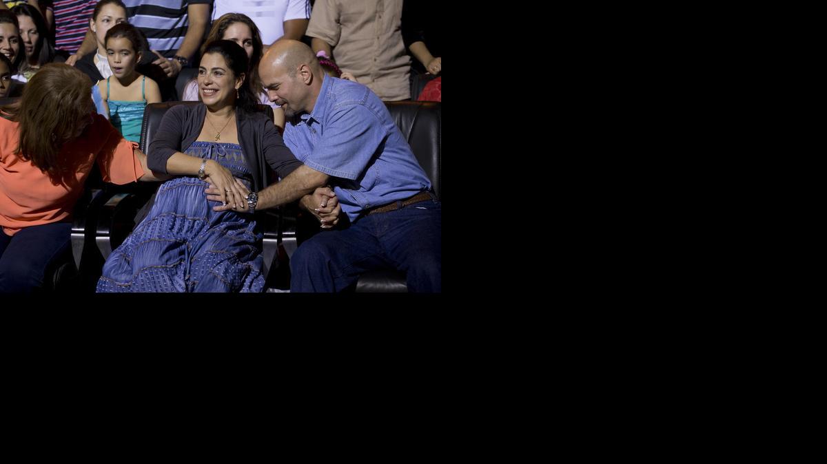 
 Gerardo Hernandez, right, a member of “The Cuban Five,” touches the belly of his pregnant wife, Adriana Perez, during a concert in Havana on Saturday, Dec. 20, 2014. The pregnancy came through artificial insemination while Hernandez was being held in the U.S.


