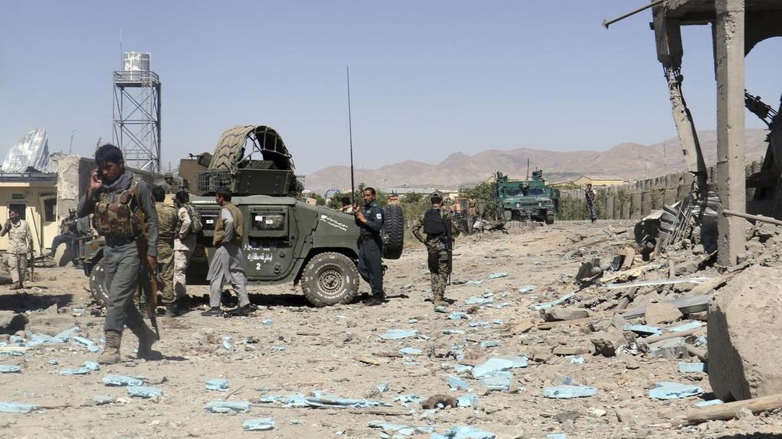In this Sunday, June. 18, 2017, file photo, security forces are deployed to the site of a suicide attack between Taliban insurgents and government forces near the main police station in eastern Paktia province, Afghanistan.