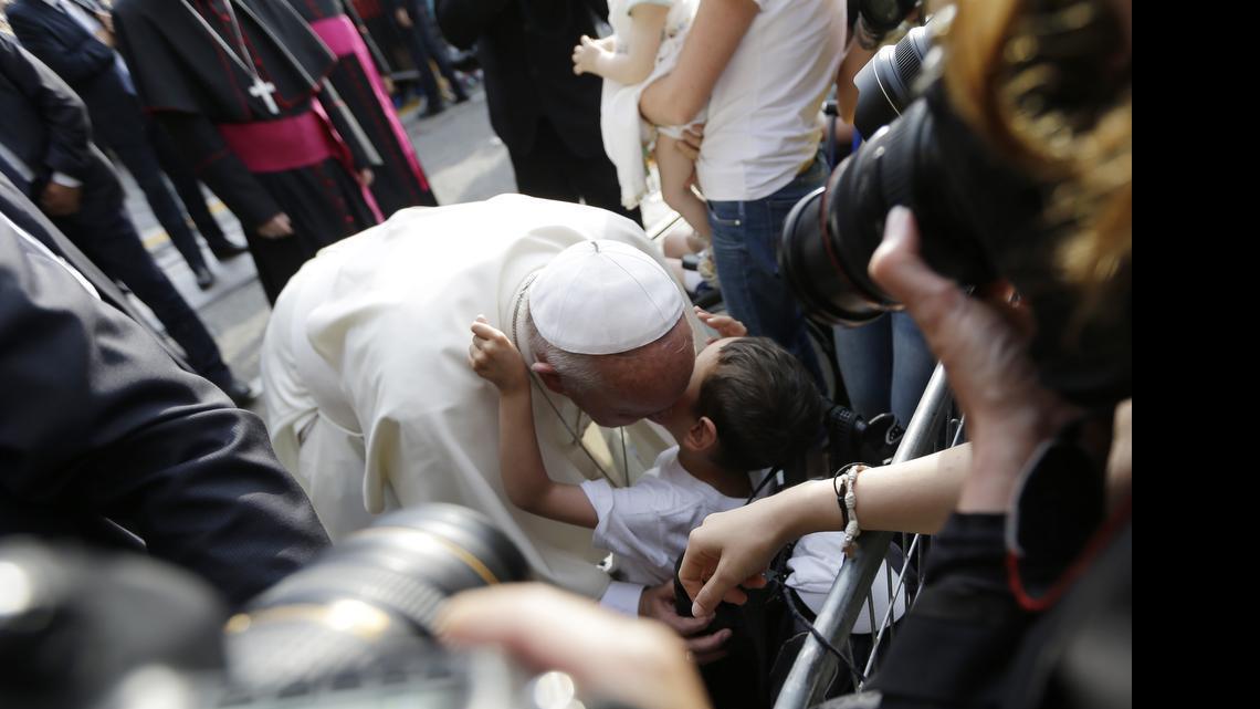 
Pope Francis kisses a child during a meeting with young people, in Turin, Italy, Sunday, June 21, 2015. Pope Francis earlier prayed in front of the Holy Shroud, the 14 foot-long linen revered by some as the burial cloth of Jesus, on display at the Cathedral of Turin. 
