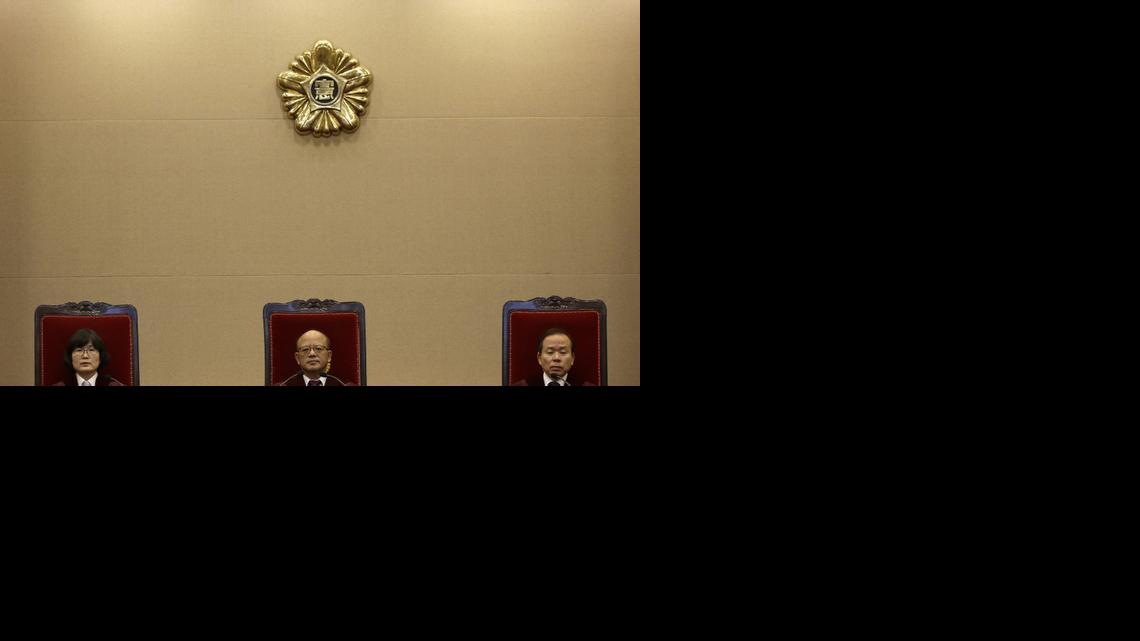 
Park Han-chul, center, president of South Korea's Constitutional Court, sits with other judges before the judgment at the Constitutional Court in Seoul, South Korea, Thursday, Feb. 26, 2015. 
