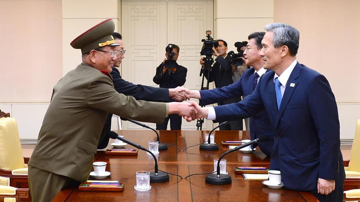
In this Aug. 22, 2015, photo provided by the South Korean Unification Ministry, South Korean National Security Director Kim Kwan-jin, right, and Unification Minister Hong Yong-pyo, second from right, shake hands with Hwang Pyong So, left, North Korea’s top political officer for the Korean People’s Army, and Kim Yang Gon, a senior North Korean official responsible for South Korean affairs, during their meeting at the border village of Panmunjom in Paju, South Korea.

