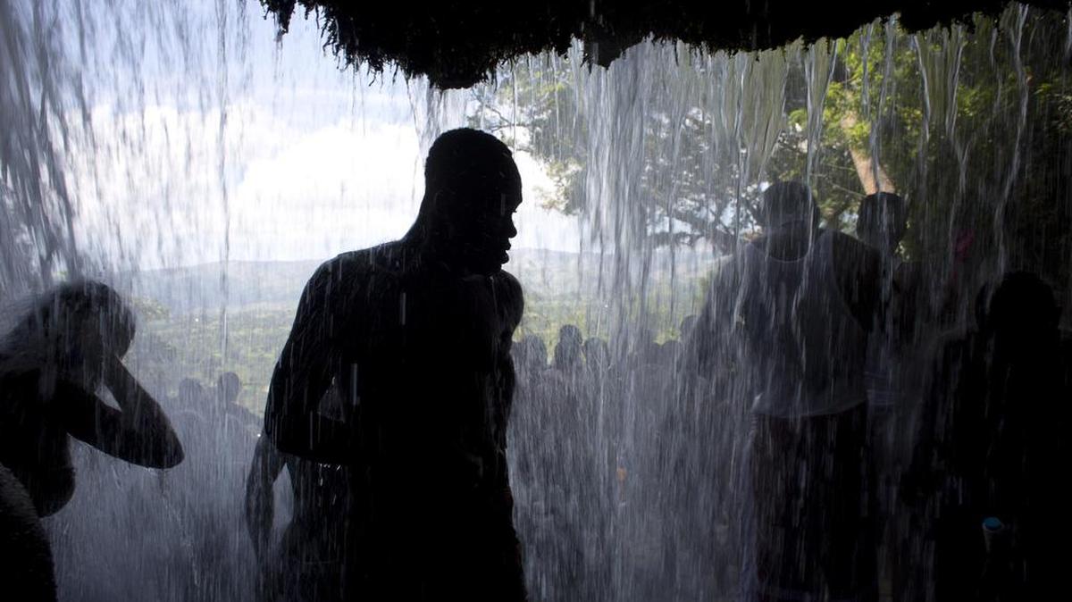 Voodoo pilgrims bathe in a waterfall believed to have purifying powers during the annual celebration in Saut d’ Eau, Haiti, Saturday, July 16, 2016. Tens of thousands of Haitians make the pilgrimage to bathe in the sacred waterfalls. A mix of Voodoo and Christian faithful along with a cohort of young, hard-partying revelers gathered Saturday in the rushing waters of Saut d’Eau, where they scrubbed their bodies with aromatic leaves and soap.